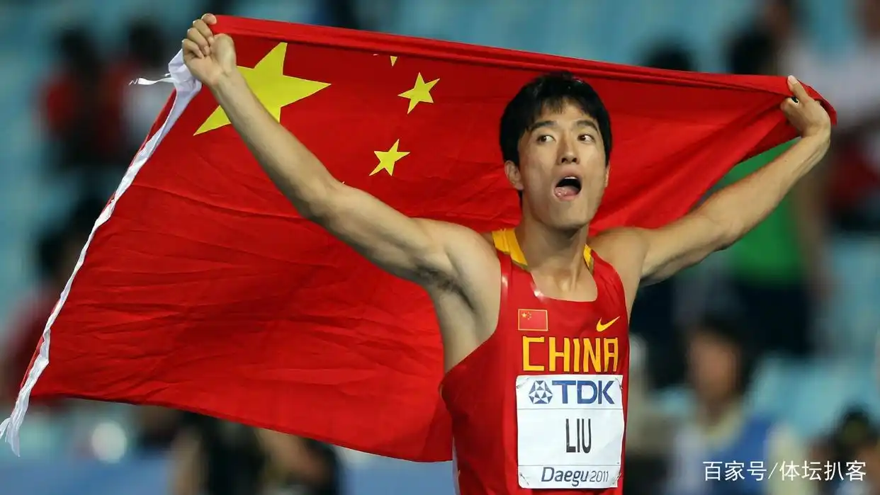 Liu Xiang running a victory lap with the Chinese flag after winning the 110m hurdles at Athens 2004