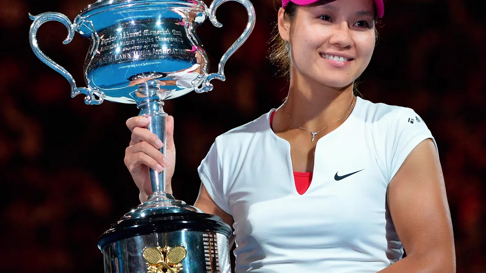 Li Na posing with the Daphne Akhurst Memorial Cup after defeating Dominika Cibulkova in the women's singles final of the 2014 Australian Open