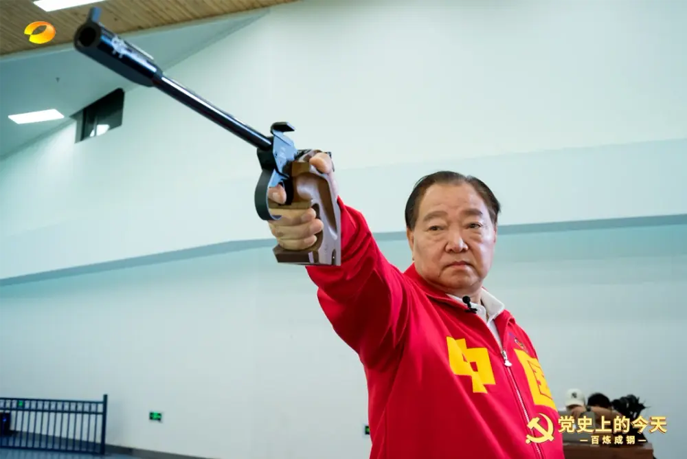 An older Xu Haifeng holding a pistol